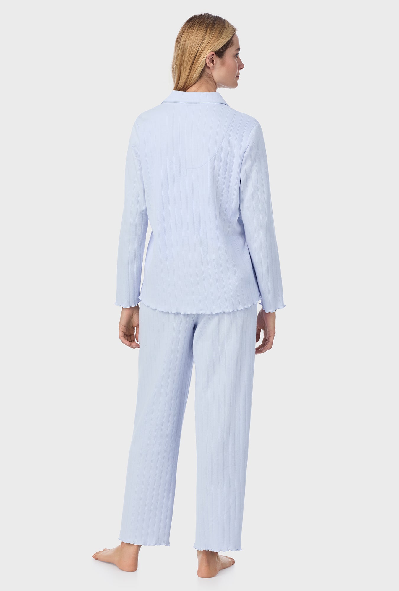 A lady wearing blue long sleeve cotton pointelle long pajama set.
