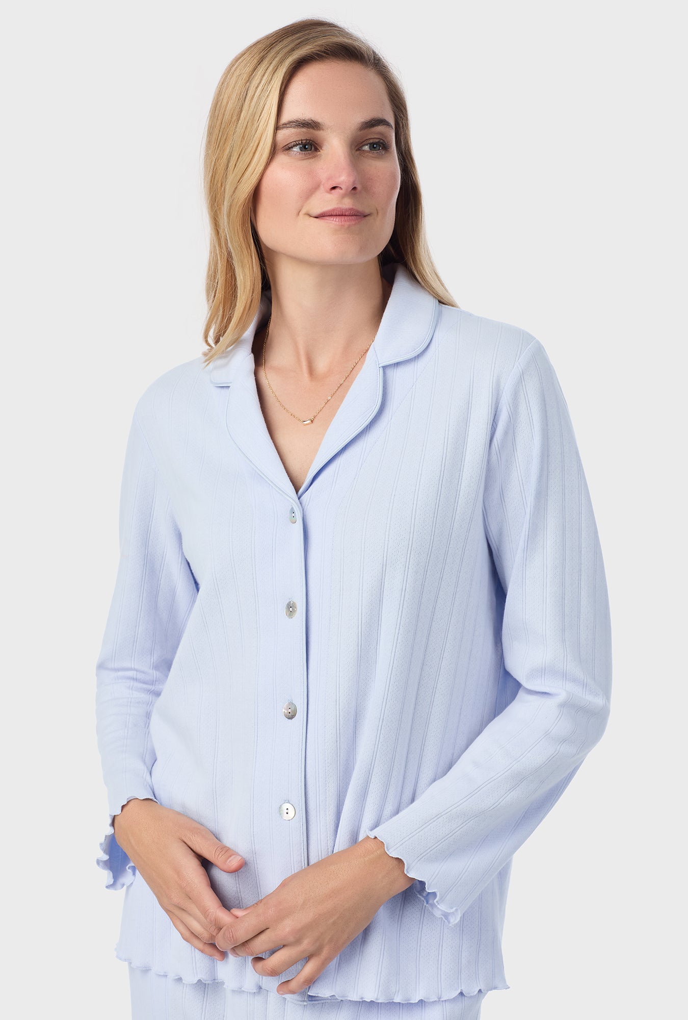 A lady wearing blue long sleeve cotton pointelle long pajama set.