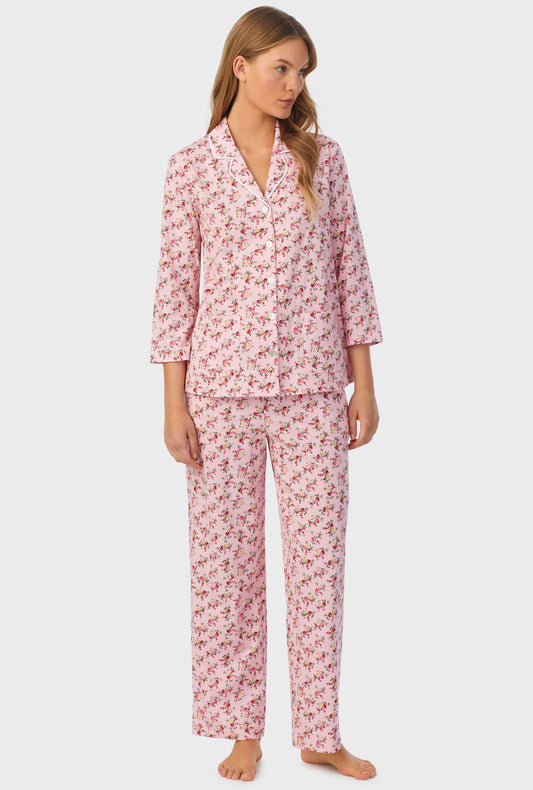 A lady wearing long sleeve pajama set with wild blooms print.