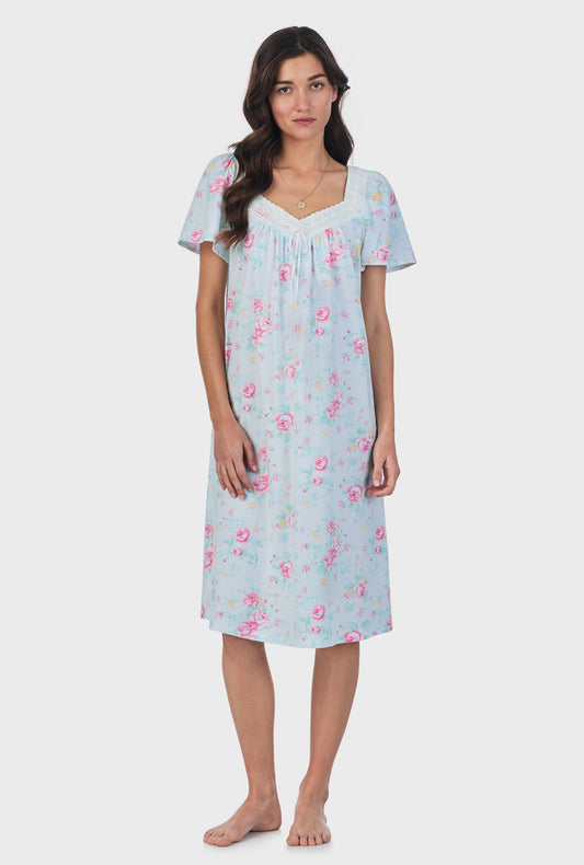 A lady wearing blue short Sleeve Cotton Waltz Nightgown with French Garden print.