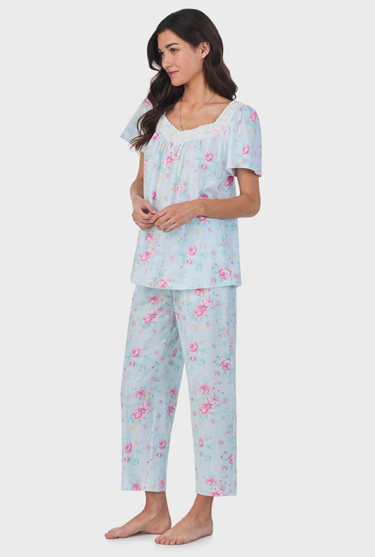 A lady wearing blue short Sleeve Cotton Capri Pajama Set with French Garden print.