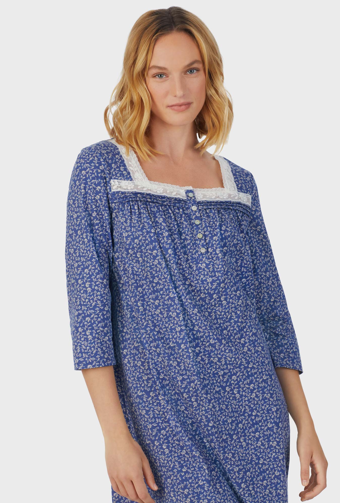 A lady wearing blue short sleeve Waltz Nightgown with Midnight Blooms print
