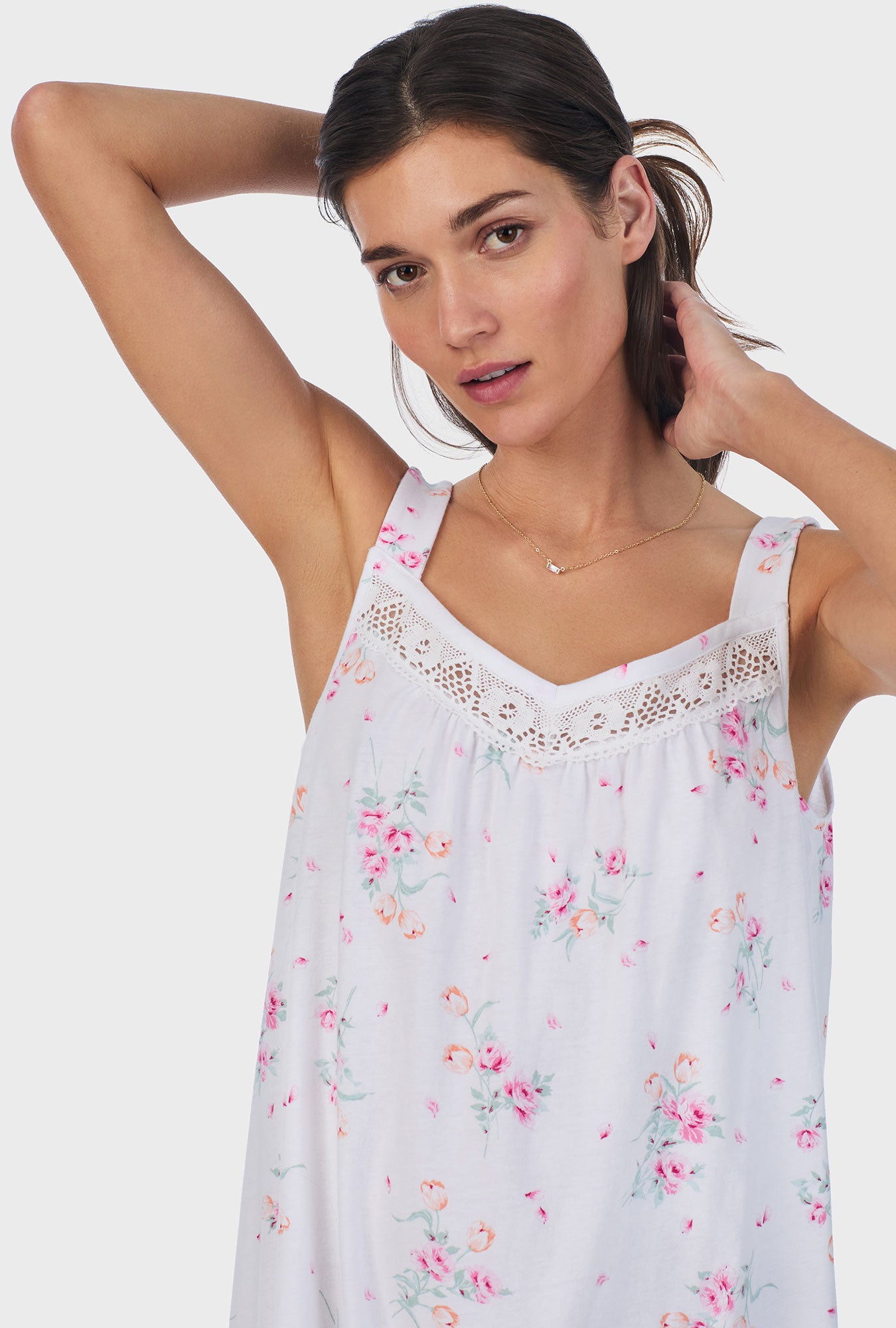 A lady wearing pink sleeveless cotton ballet nightgown with floral bouquet print.