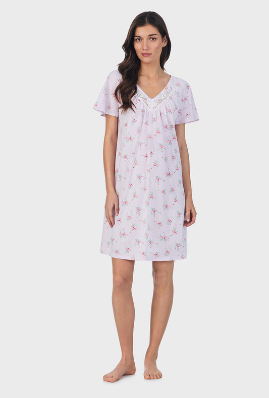 A lady wearing pink short sleeve cotton short nightgown with sweet blooms print.