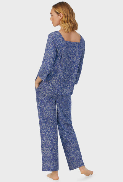 A lady wearing blue short sleeve Long Pajama Set with Midnight Blooms print