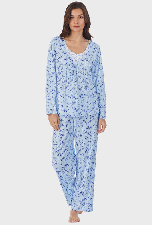 A lady wearing blue long sleeve cotton long pajama set with winter floral print.