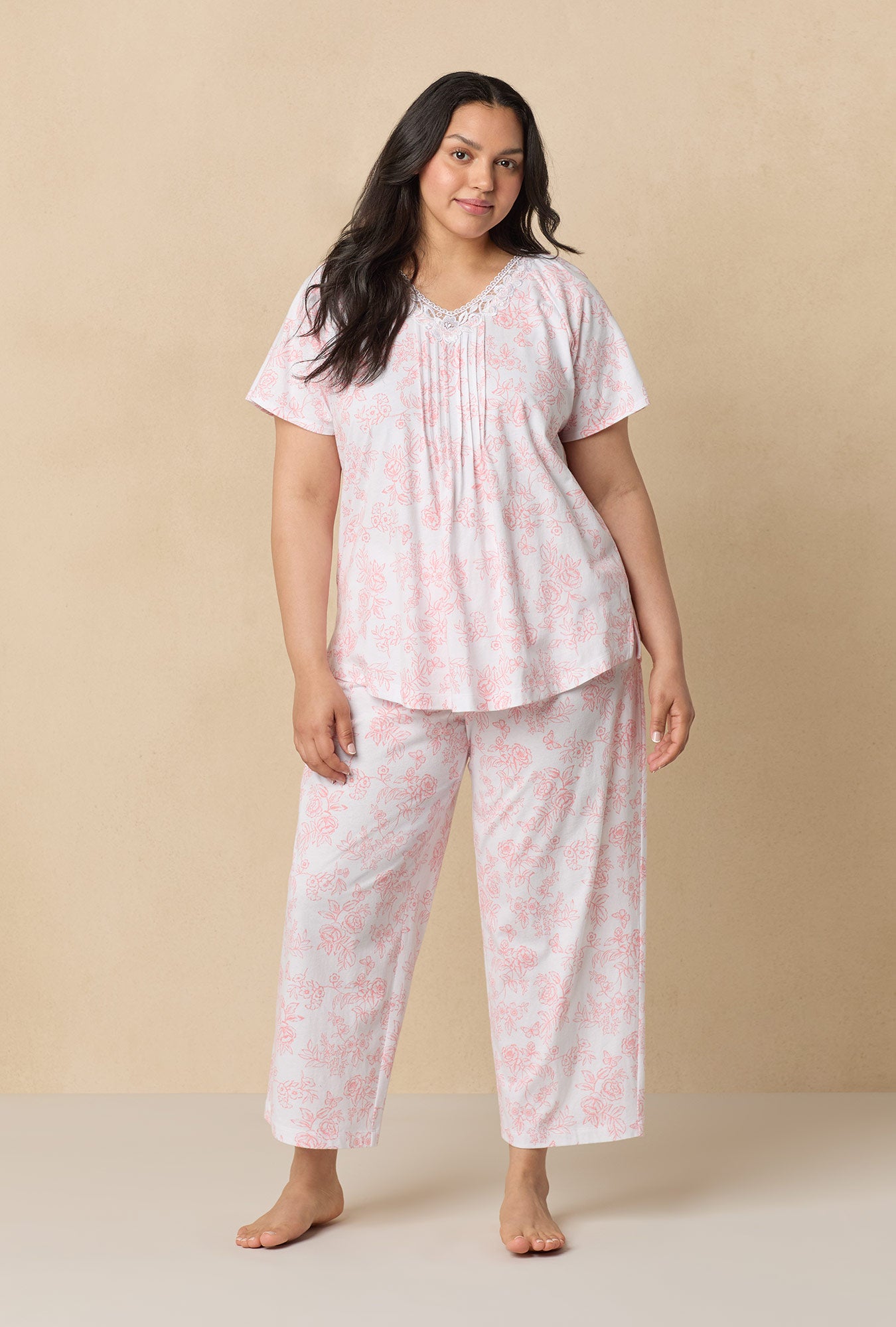 A lady wearing Coral Toile Capri Cotton Knit Pajama Set