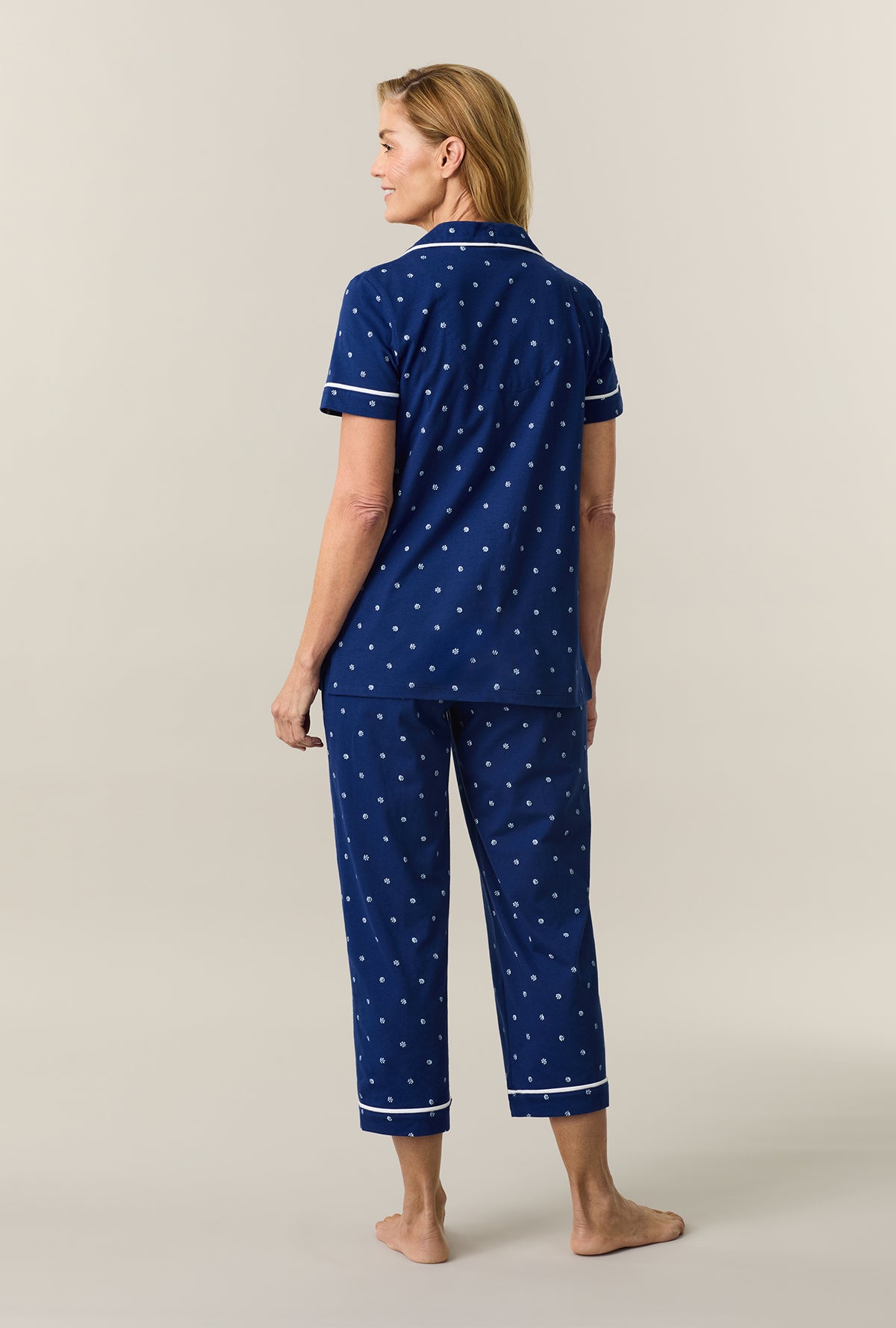 A lady wearing Blue Depths Ditsy Cotton Capri Pajama Set