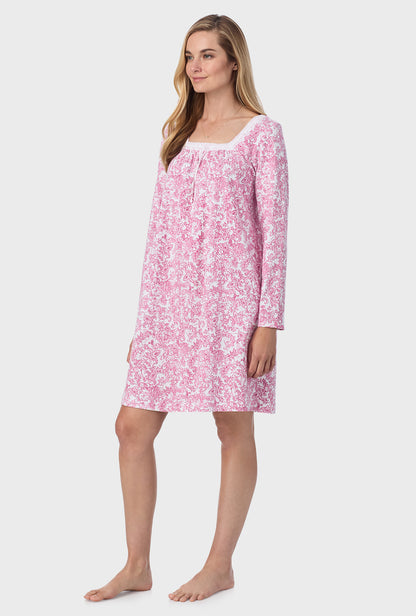 A lady wearing short nightgown with berry paisley print