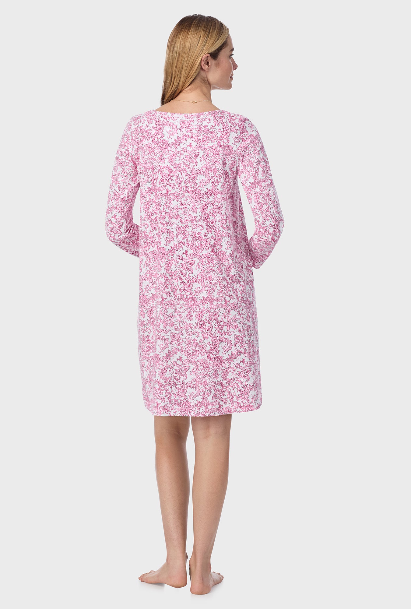 A lady wearing short nightgown with berry paisley print