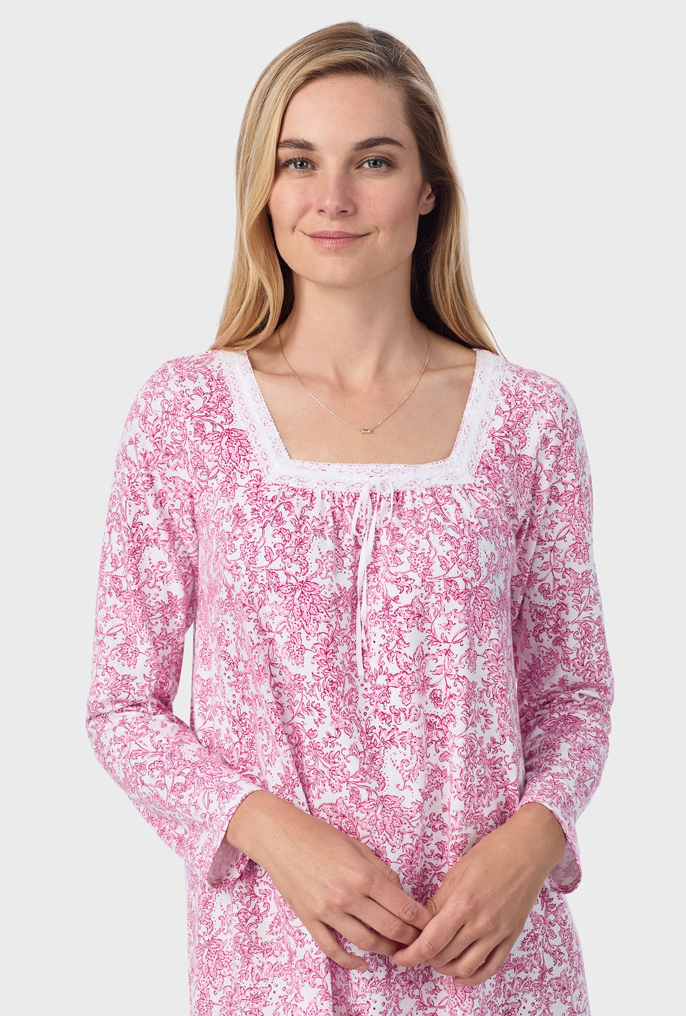 A lady wearing short nightgown with berry paisley print