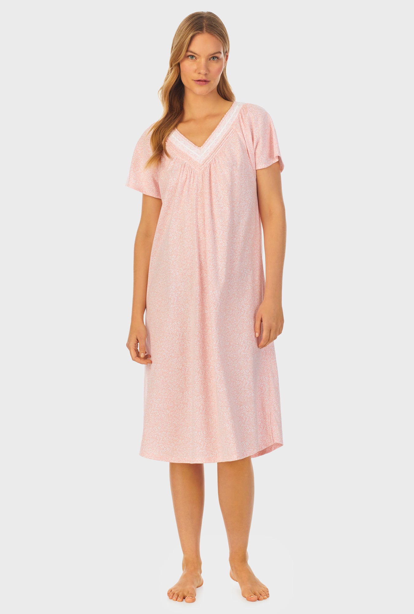 A lady wearing orange short sleeve Cotton Waltz Nightgown with Floral Vine print
