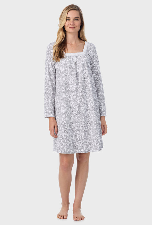 A lady wearing short nightgown with grey paisley print