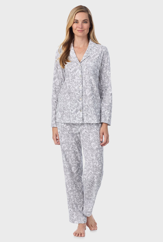 A lady wearing long pajama set with grey paisley print