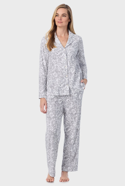 A lady wearing long pajama set with grey paisley print