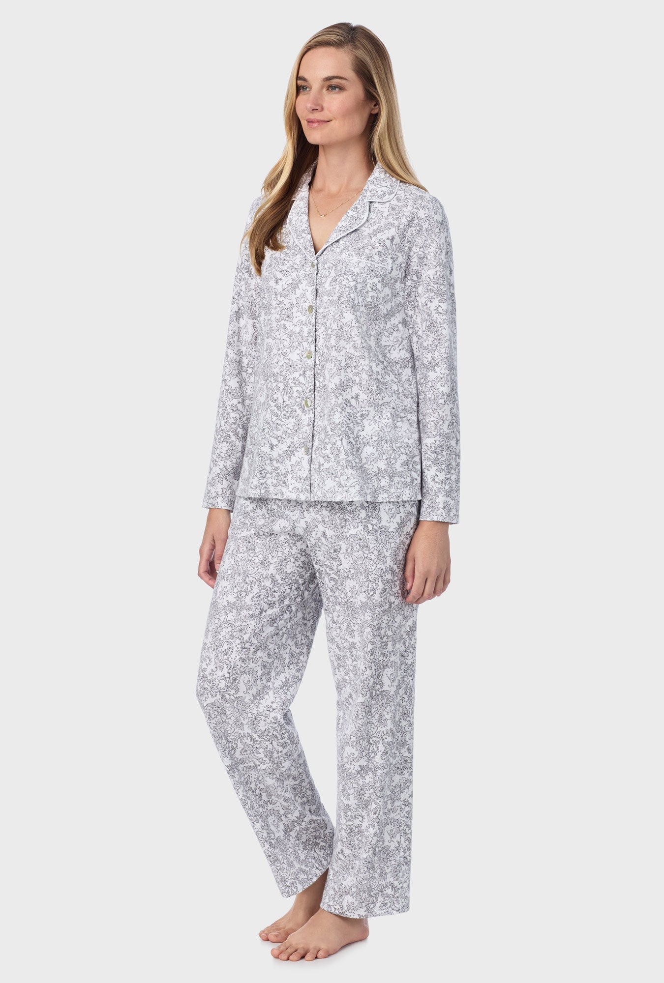 A lady wearing long pajama set with grey paisley print