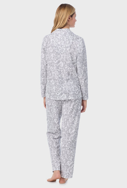 A lady wearing long pajama set with grey paisley print