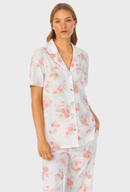 A lady wearing white short sleeve Capri Pajama Set with Watercolor Fleur print