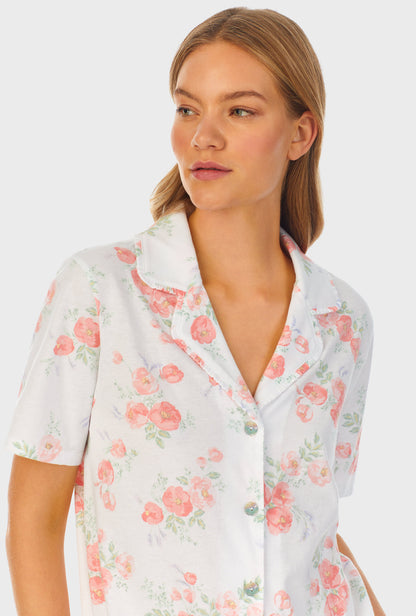 A lady wearing white short sleeve Capri Pajama Set with Watercolor Fleur print