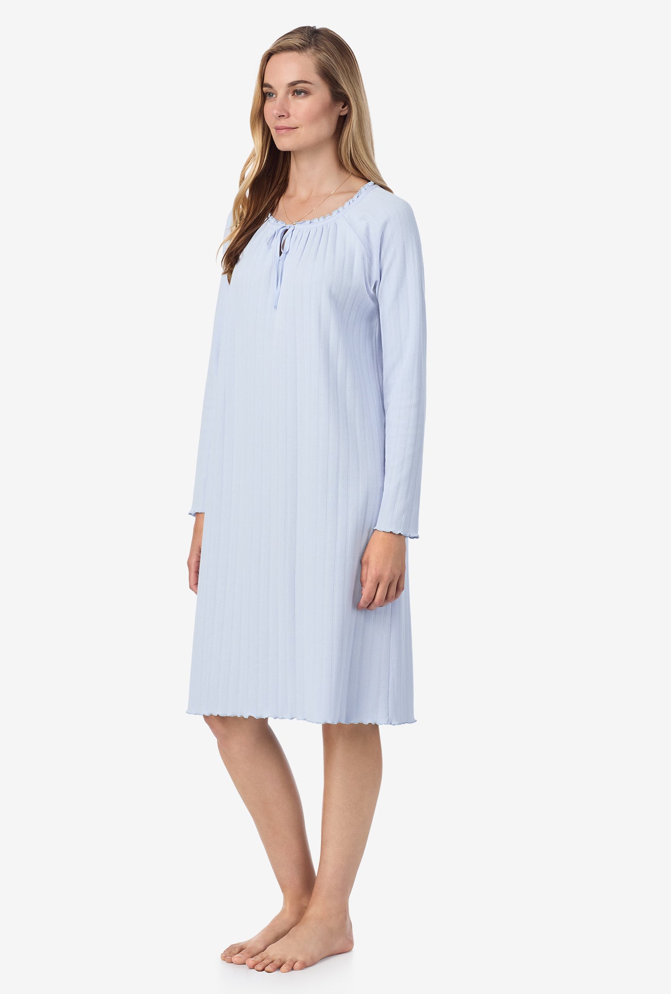 A lady wearing blue long sleeve cotton pointelle waltz nightgown.