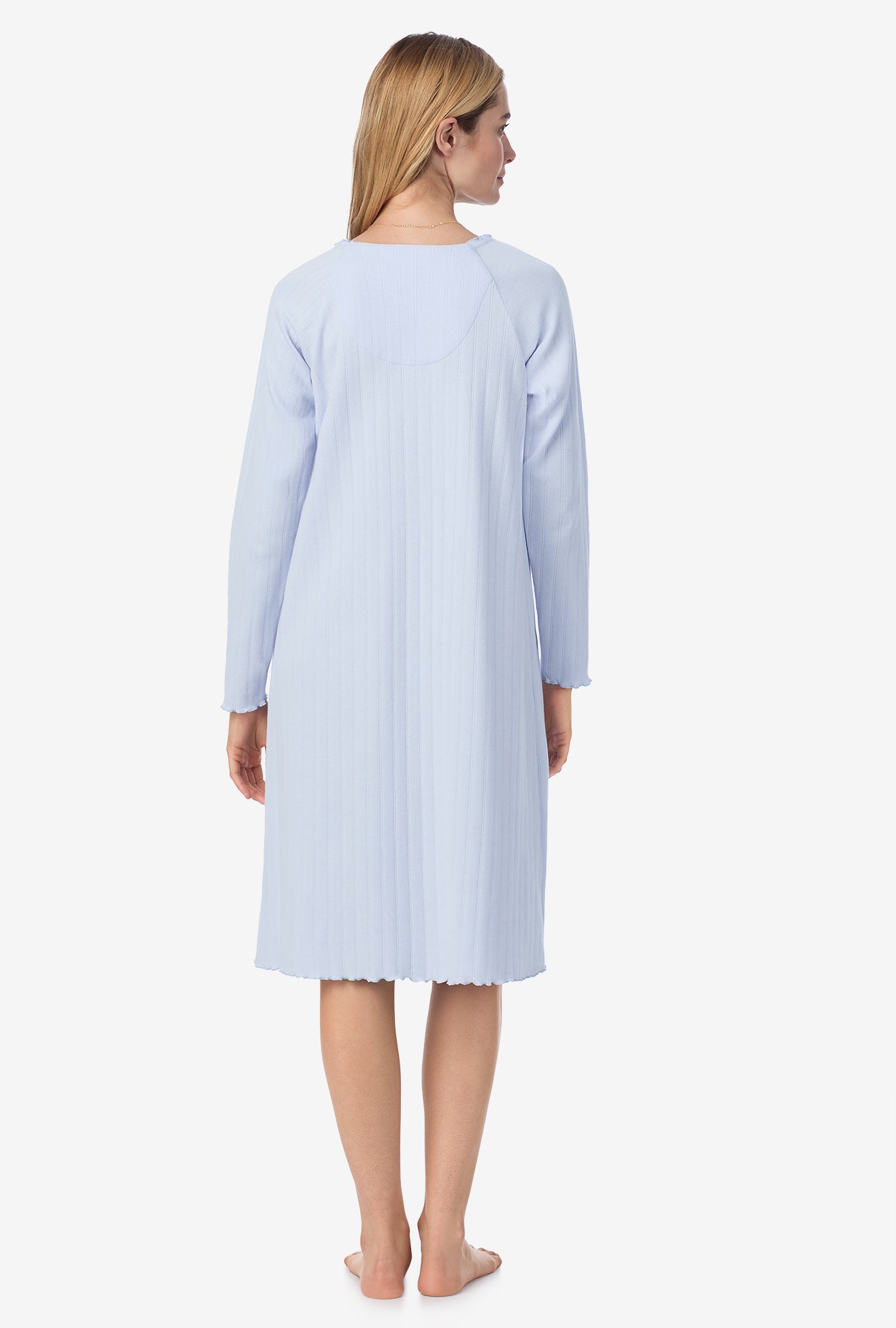 A lady wearing blue long sleeve cotton pointelle waltz nightgown.