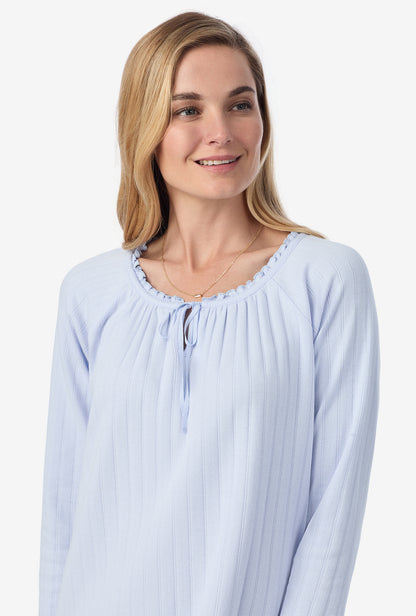 A lady wearing blue long sleeve cotton pointelle waltz nightgown.