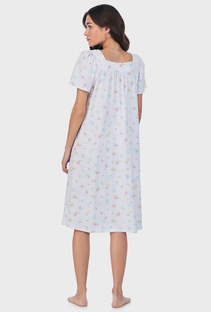 A lady wearing white short Sleeve Cotton Waltz Nightgown with Cottage Bouquet print.
