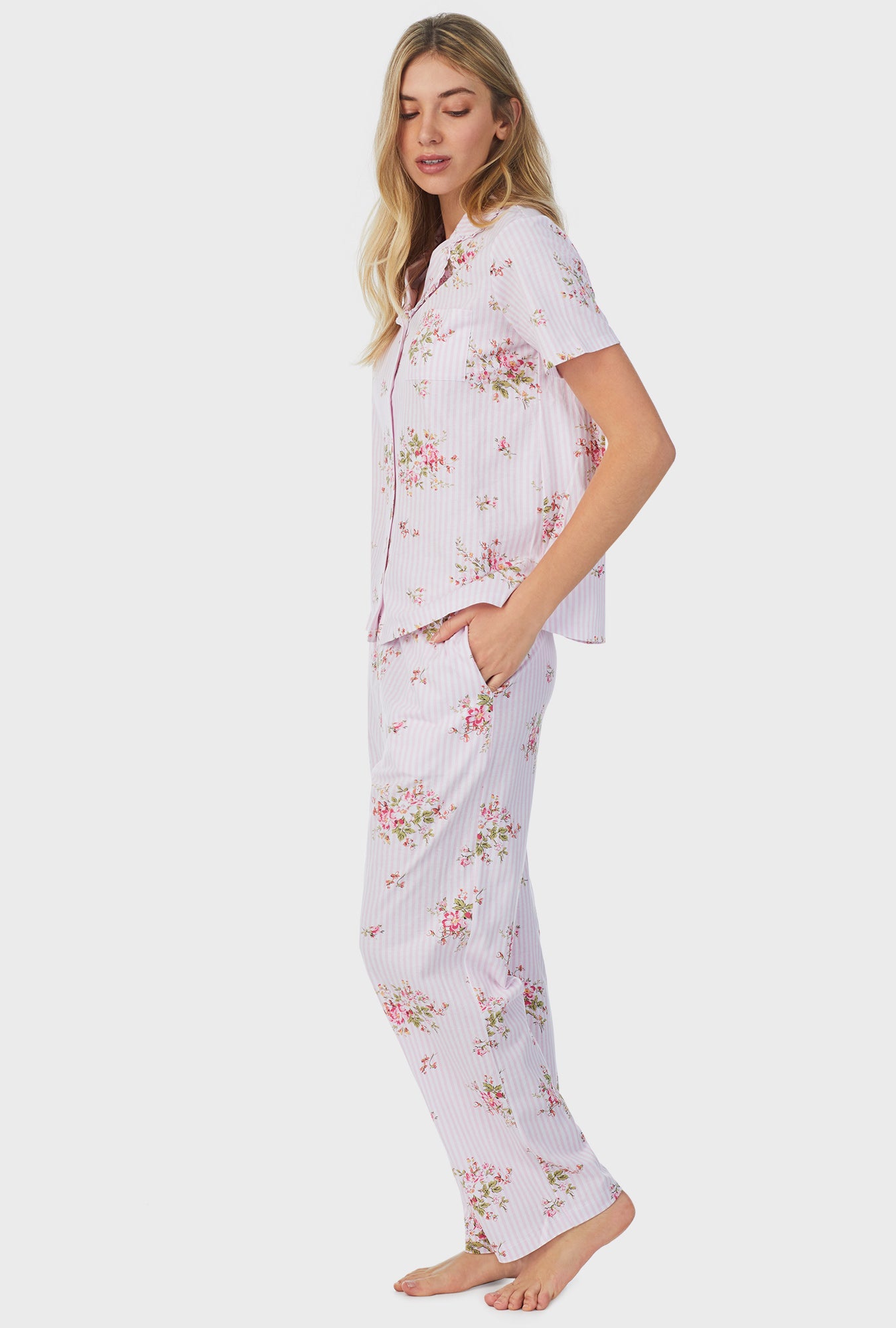 A lady wearing pink short sleeve long petite pajama set with fleur print