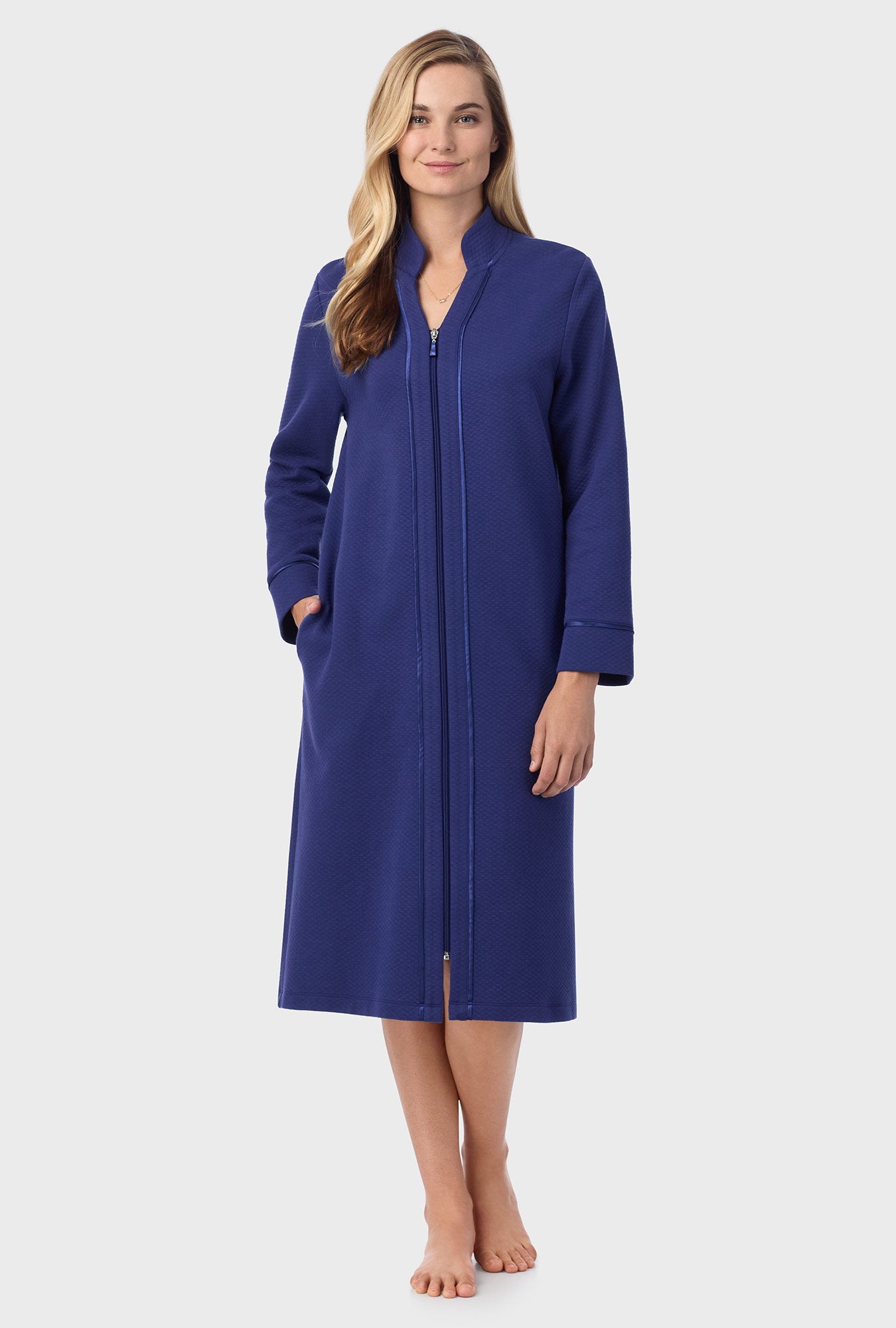 A lady wearing navy long sleeve diamond quilted zip robe.