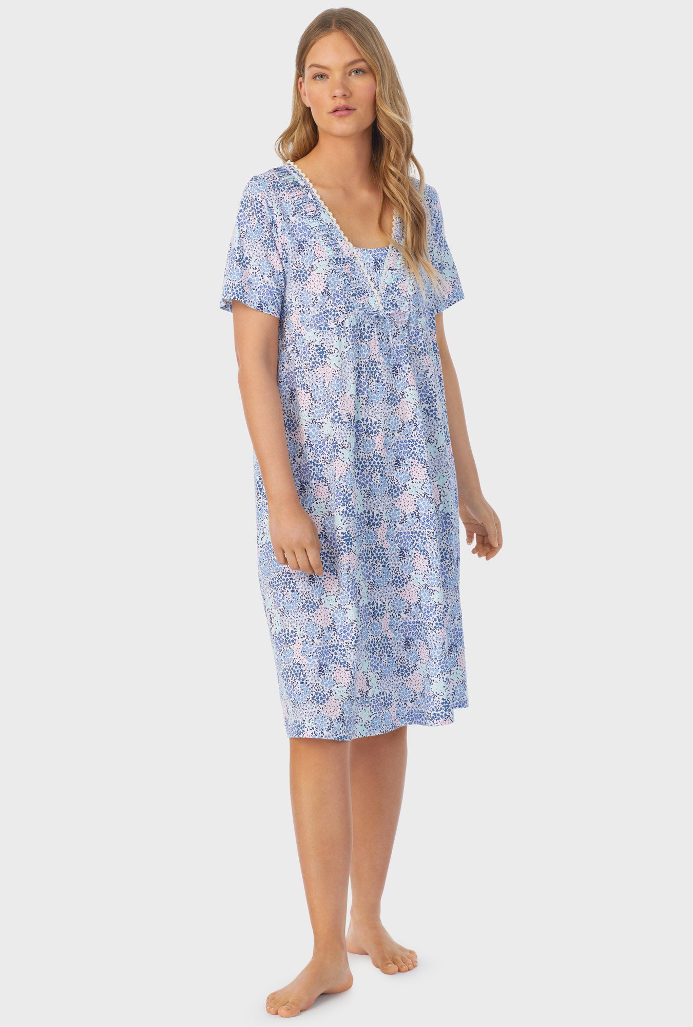 A lady wearing a short sleeve waltz nightgown with midnight dream print.
