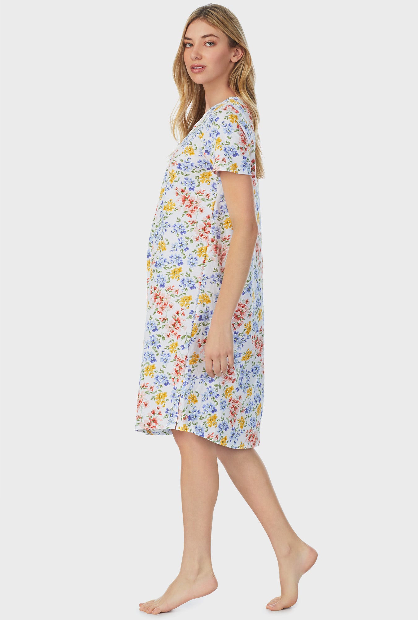 A lady wearing short sleeve waltz nightgown with multi floral print.