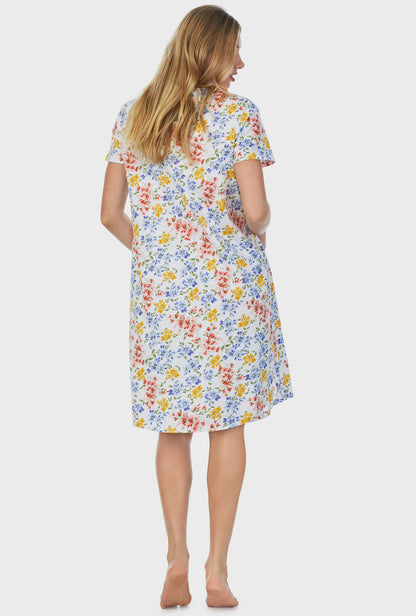 A lady wearing short sleeve waltz nightgown with multi floral print.