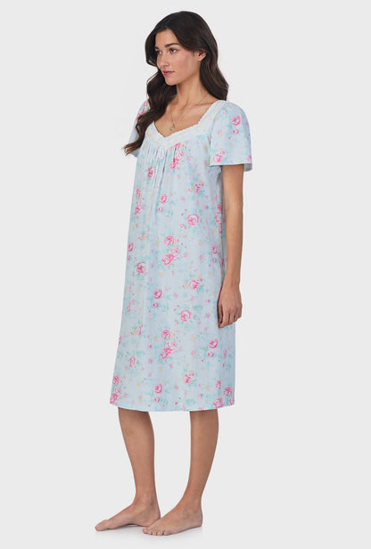 A lady wearing blue short Sleeve Cotton Waltz Nightgown with French Garden print.