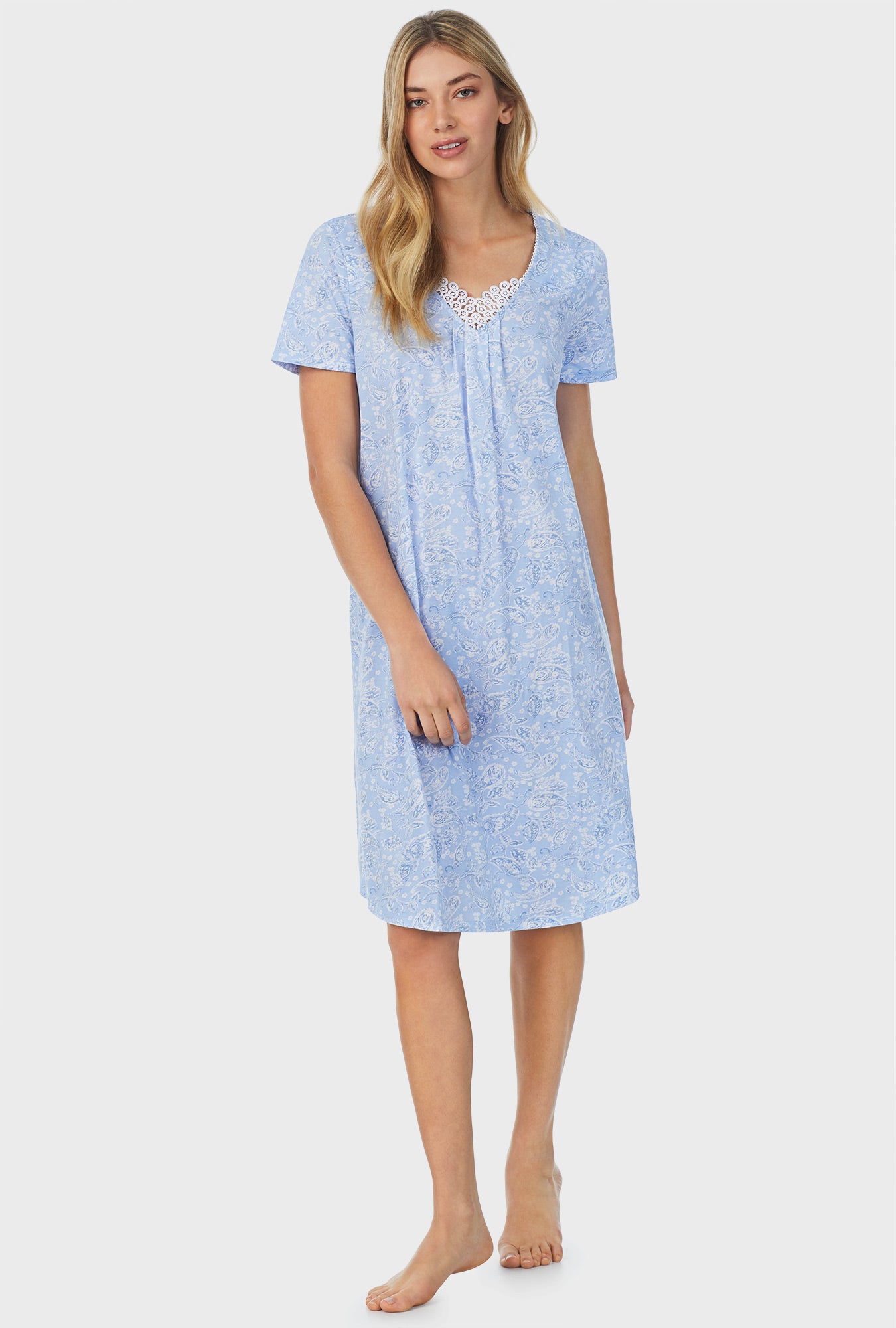 A lady wearing blue short sleeve waltz nightgown with blooming paisley print.