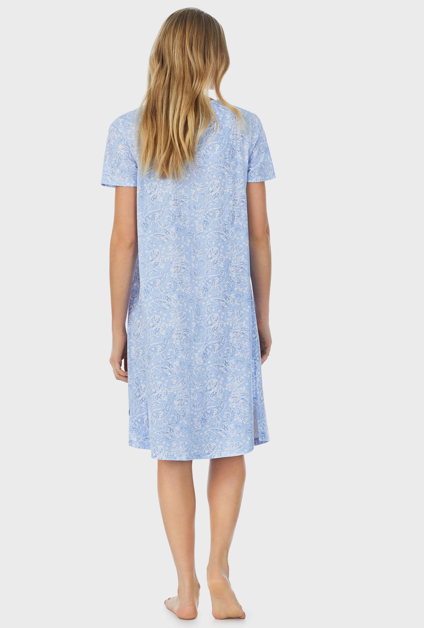 A lady wearing blue short sleeve waltz nightgown with blooming paisley print.