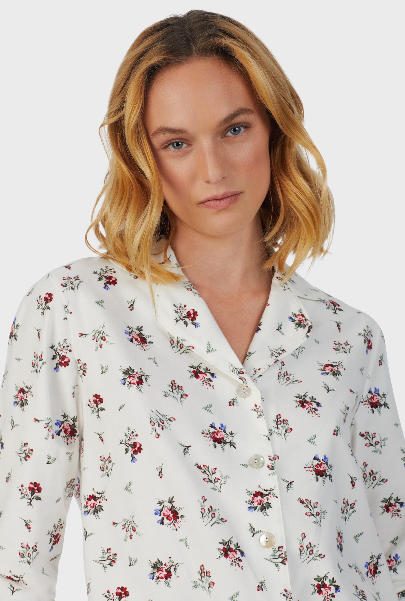 A lady wearing white long sleeve cotton rayon flannel wild flower pajama set.