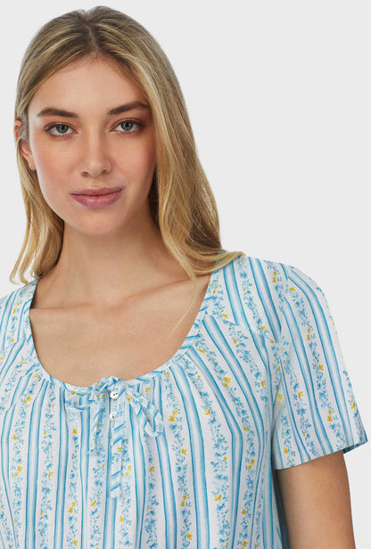 A lady wearing blue short sleeve short nightgown with floral stripes.