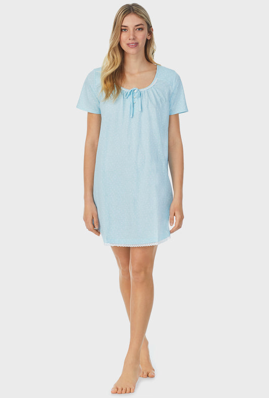 A lady wearing blue short sleeve short nightgown with aqua dots.