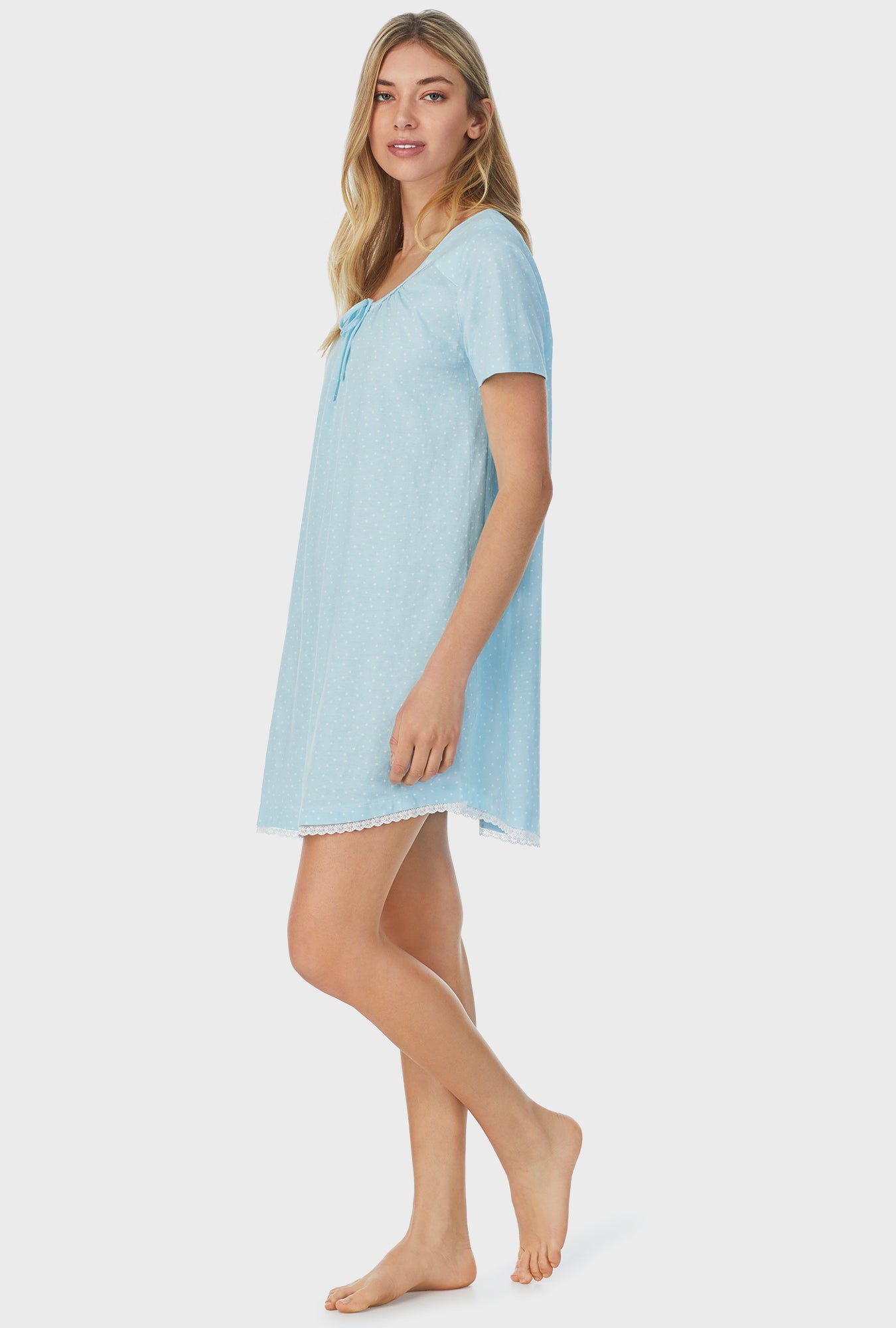 A lady wearing blue short sleeve short nightgown with aqua dots.