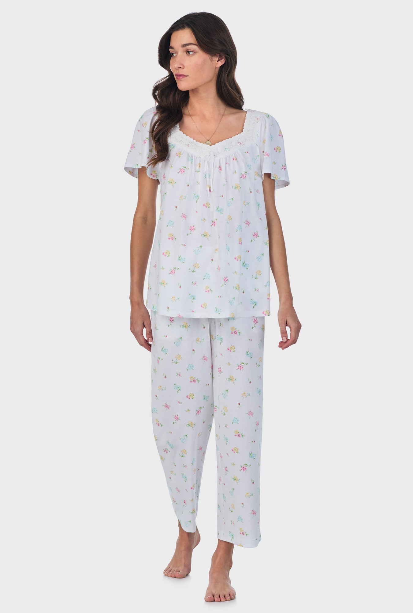 A lady wearing white short Sleeve Cotton Capri Pajama Set with Cottage Bouquet print.