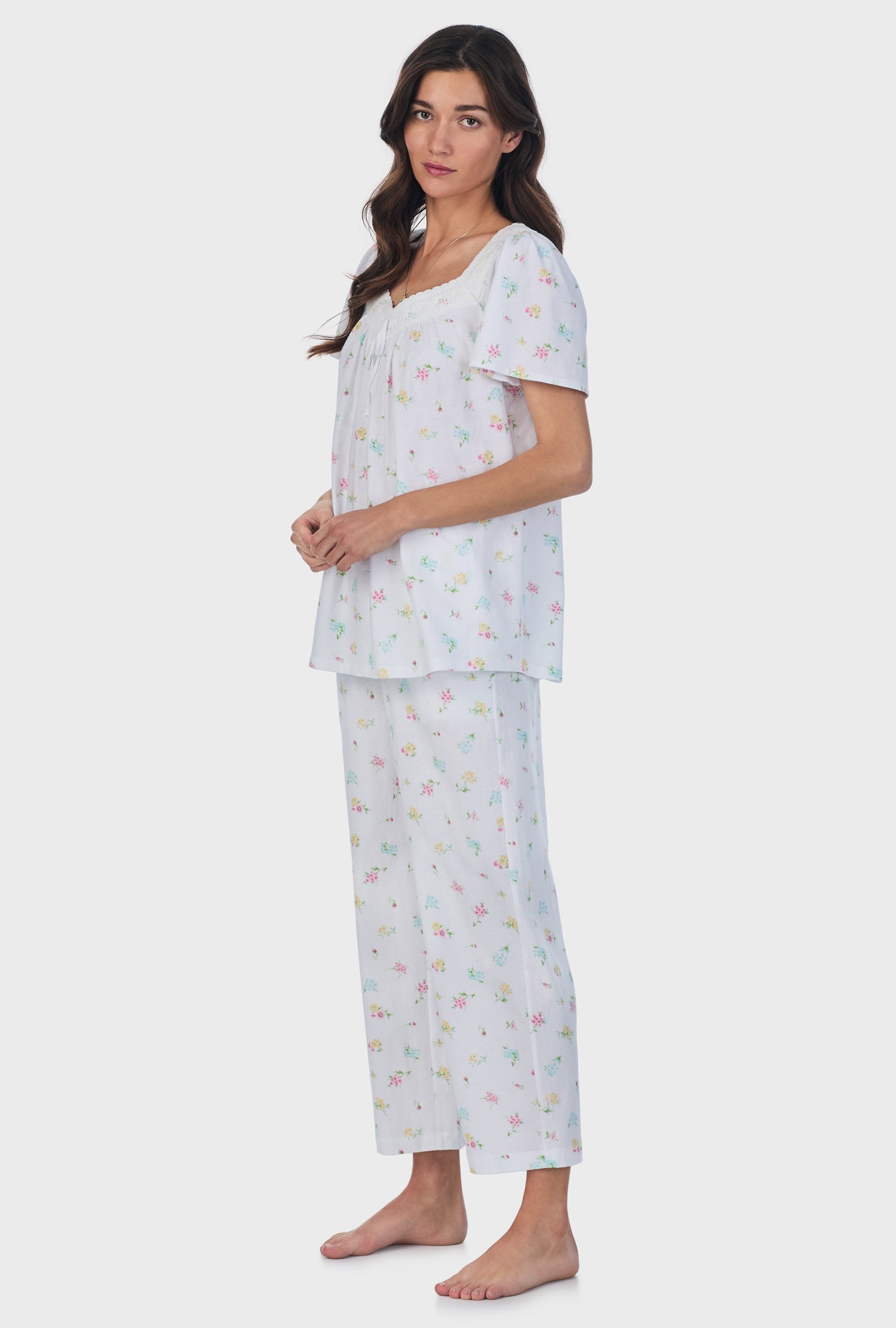 A lady wearing white short Sleeve Cotton Capri Pajama Set with Cottage Bouquet print.