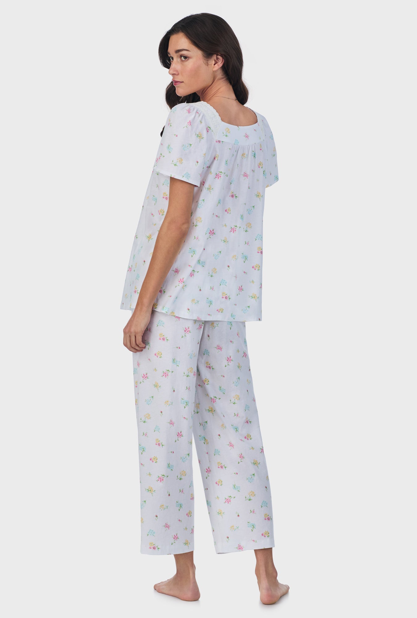 A lady wearing white short Sleeve Cotton Capri Pajama Set with Cottage Bouquet print.