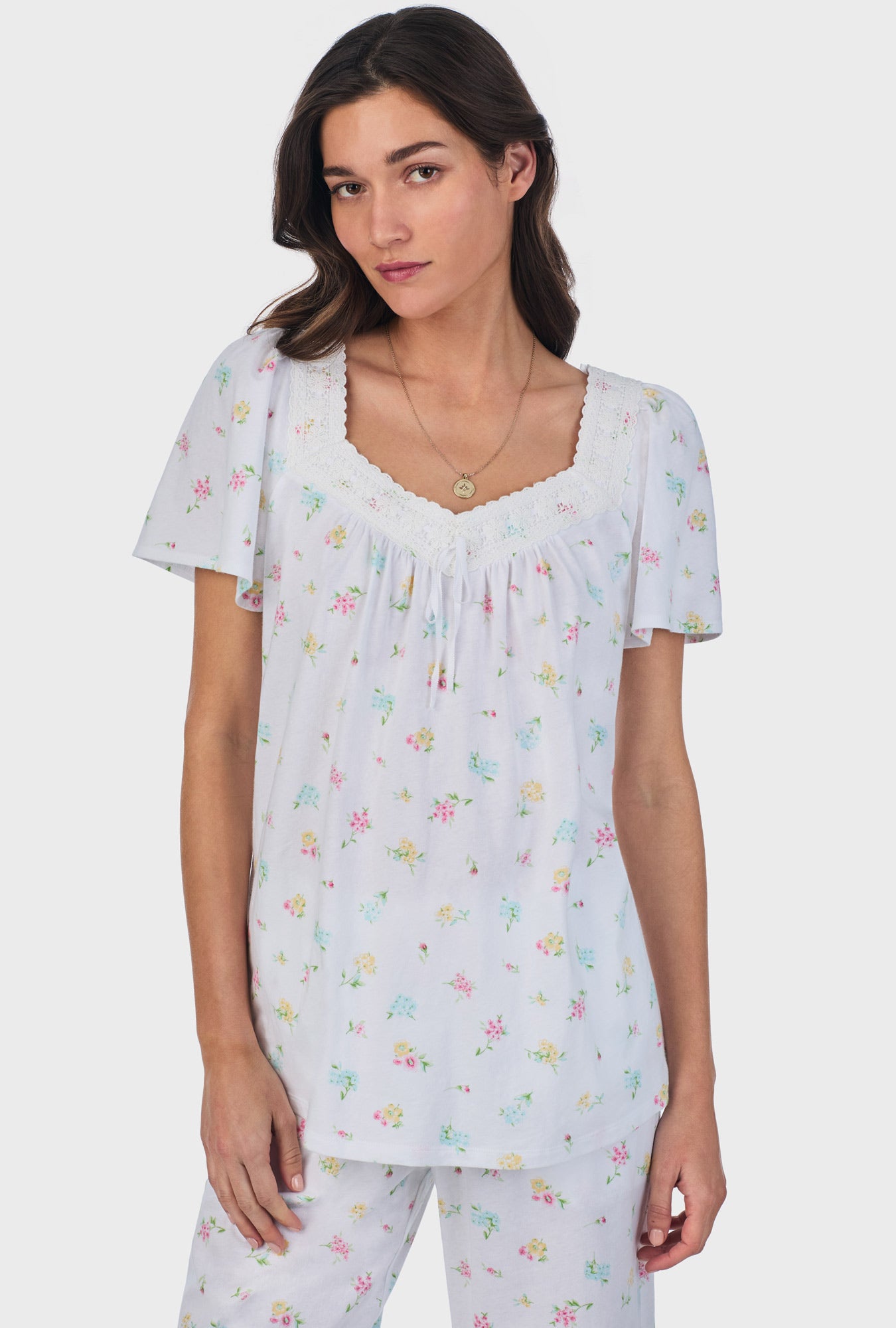 A lady wearing white short Sleeve Cotton Capri Pajama Set with Cottage Bouquet print.