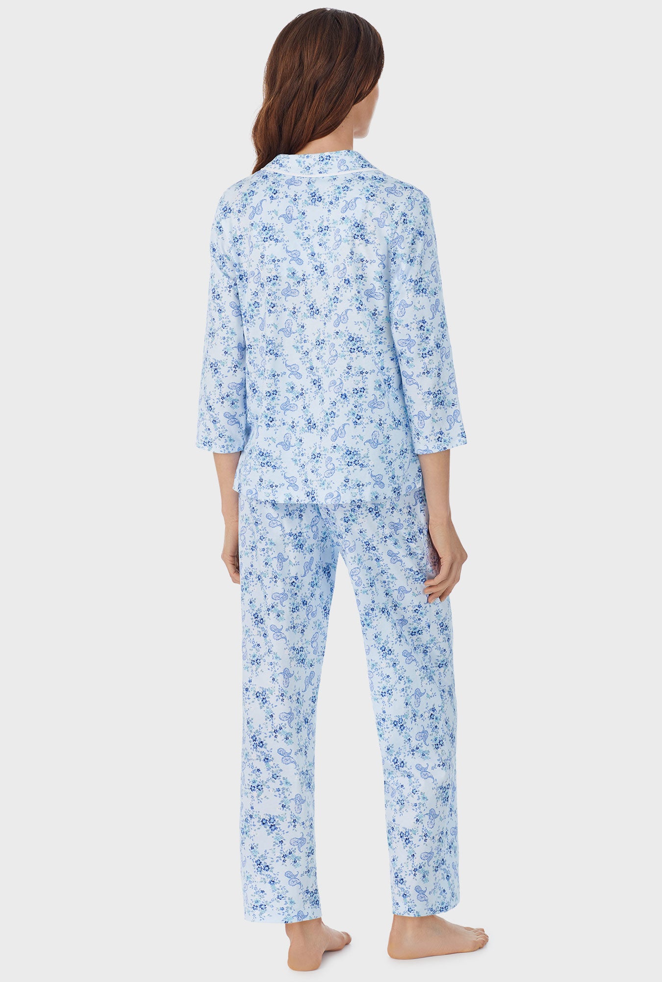 A lady wearing white long pajama set with Paisley Bouquet print