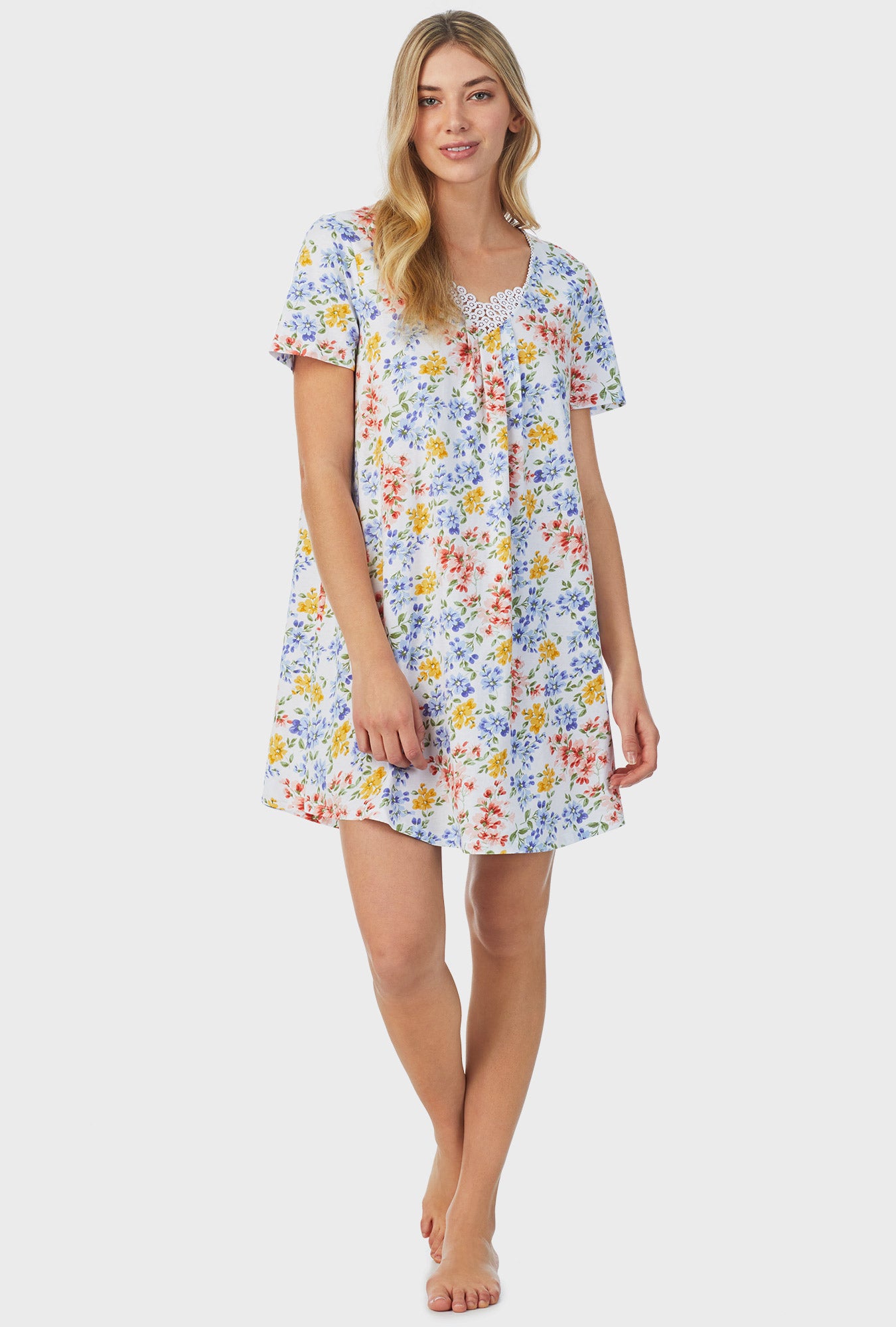 A lady wearing short sleeve short nightgown with multi floral print.