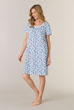 A lady wearing Twilight Paisley Short Sleeve Cotton Interlock Short Nightgown looking down