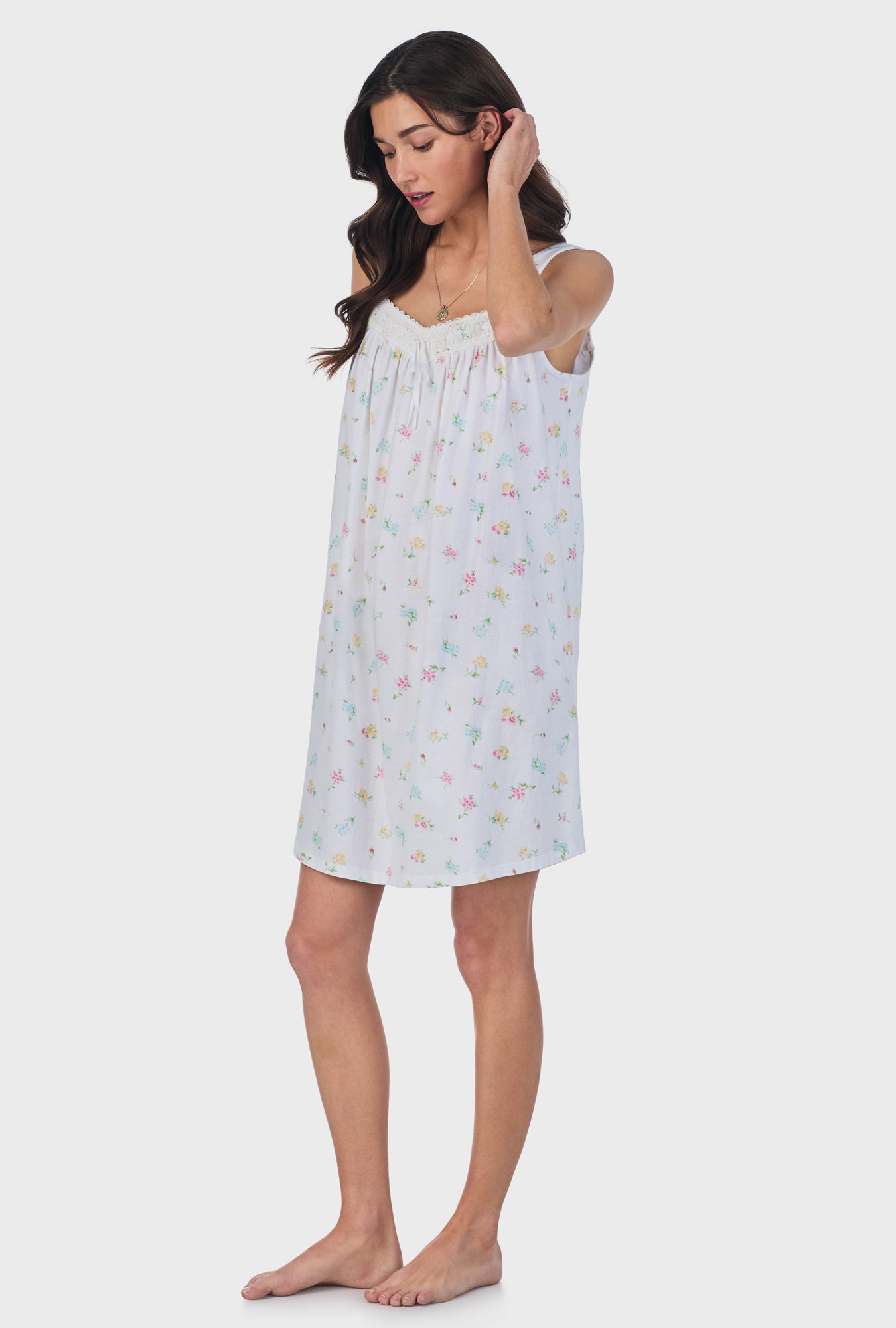 A lady wearing white sleeveless Cotton Short Nightgown with Cottage Bouquet print.