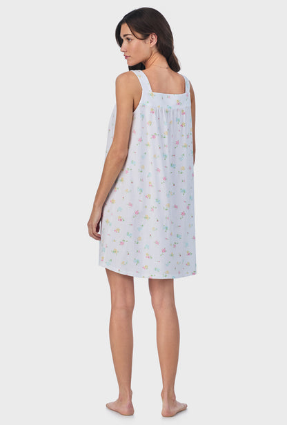 A lady wearing white sleeveless Cotton Short Nightgown with Cottage Bouquet print.