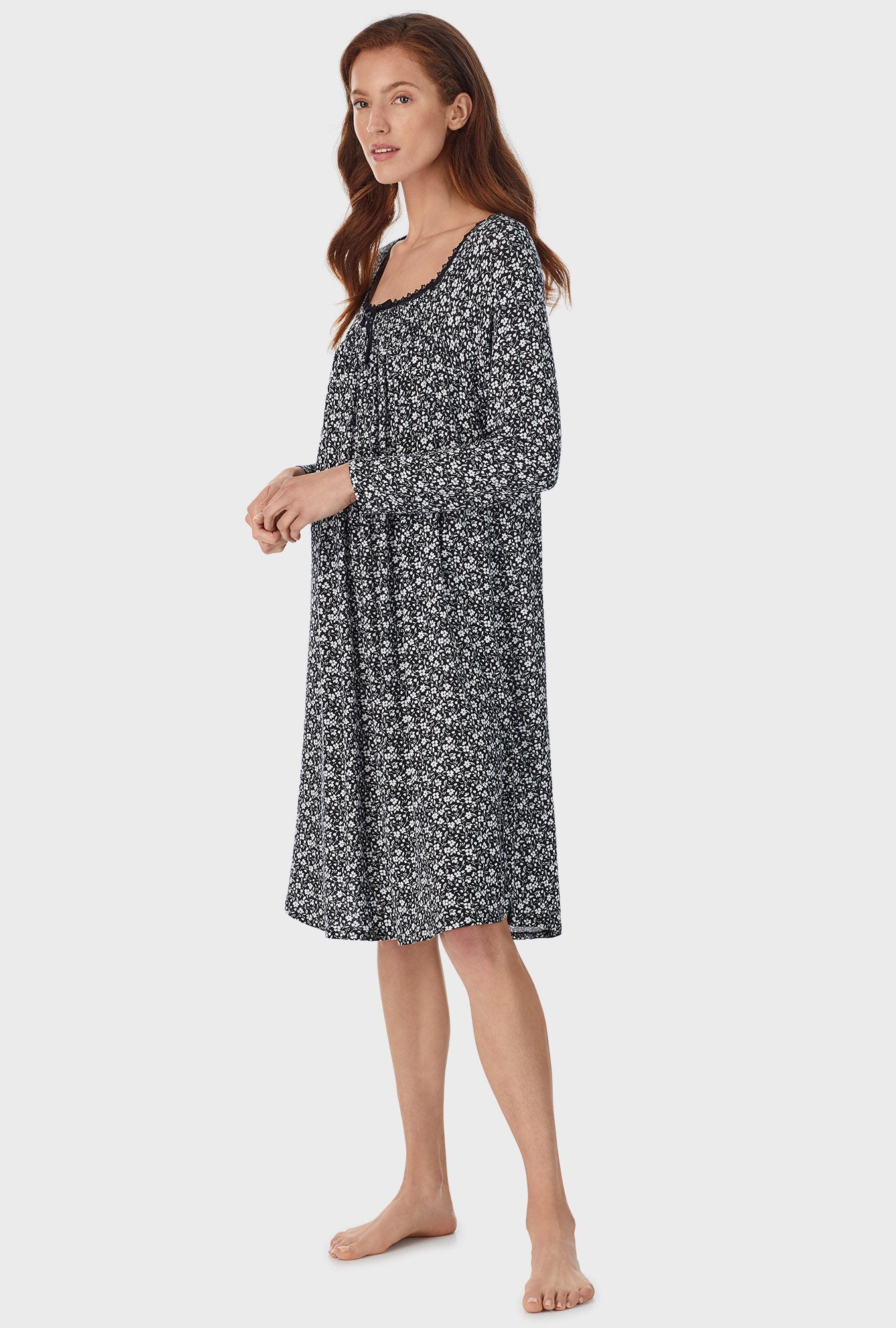  A lady wearing black waltz nightgown with midnight ditsy print
