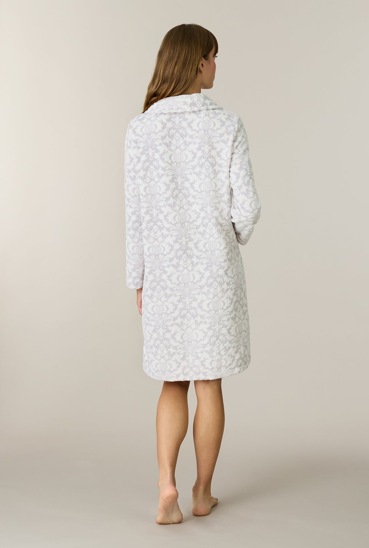 A lady wearing Pearl Damask Two-Tone Velour Short Zip Robe back view